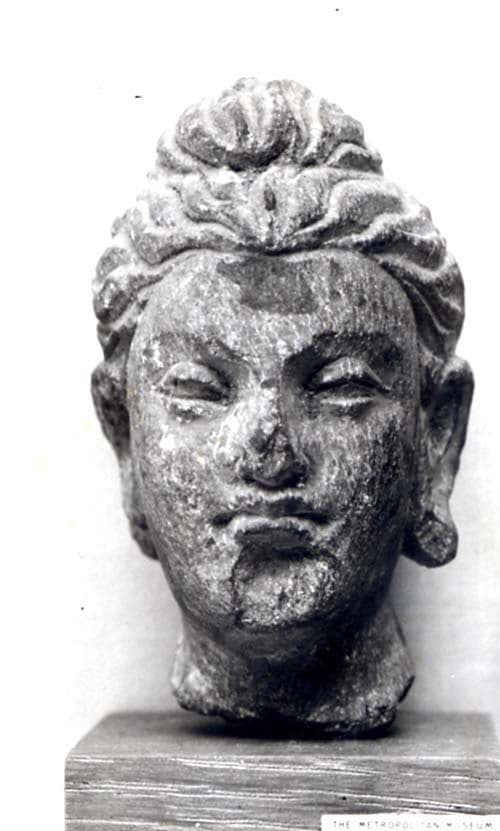 A weathered stone Buddha