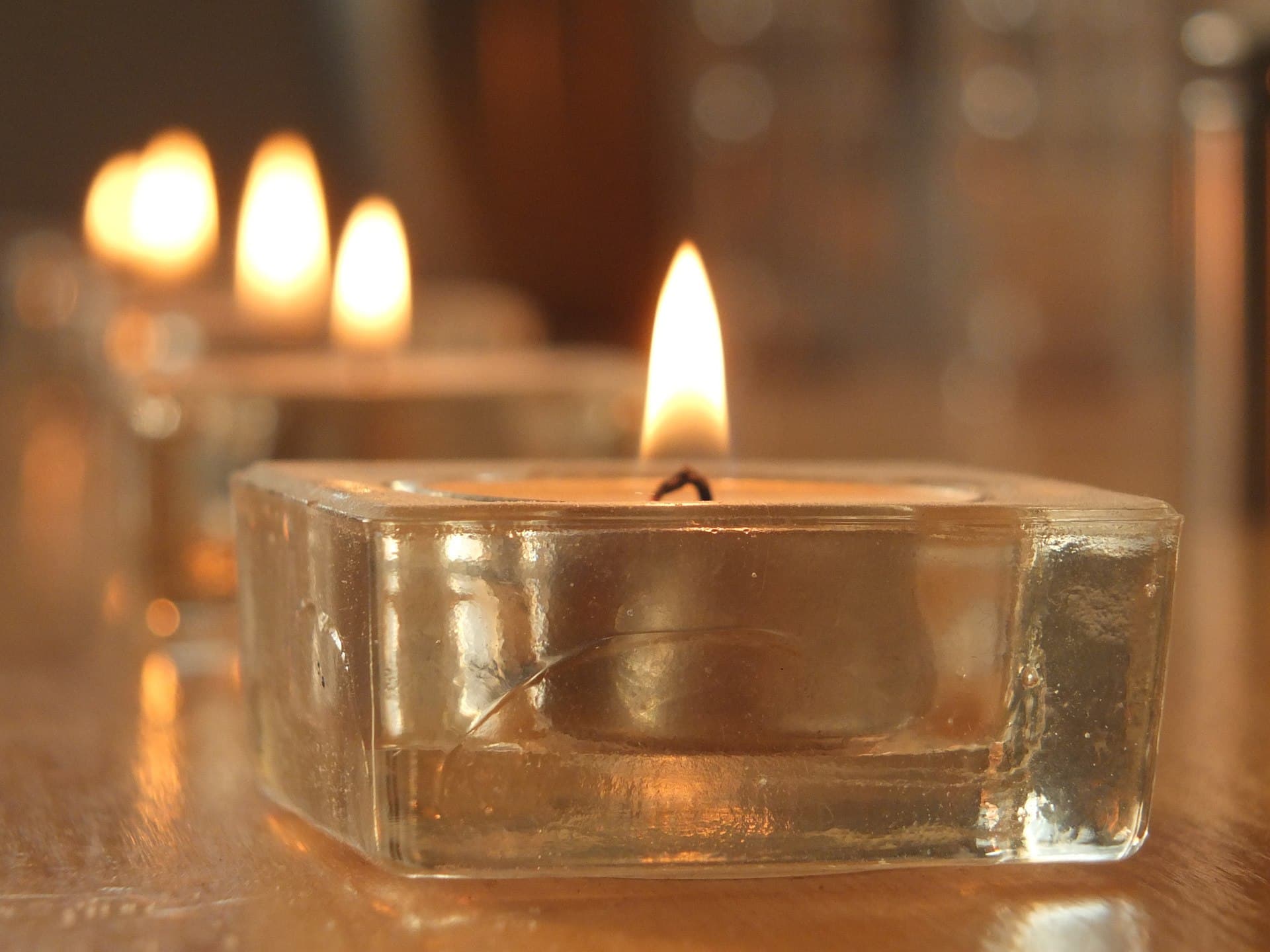 A single candle flame in darkness