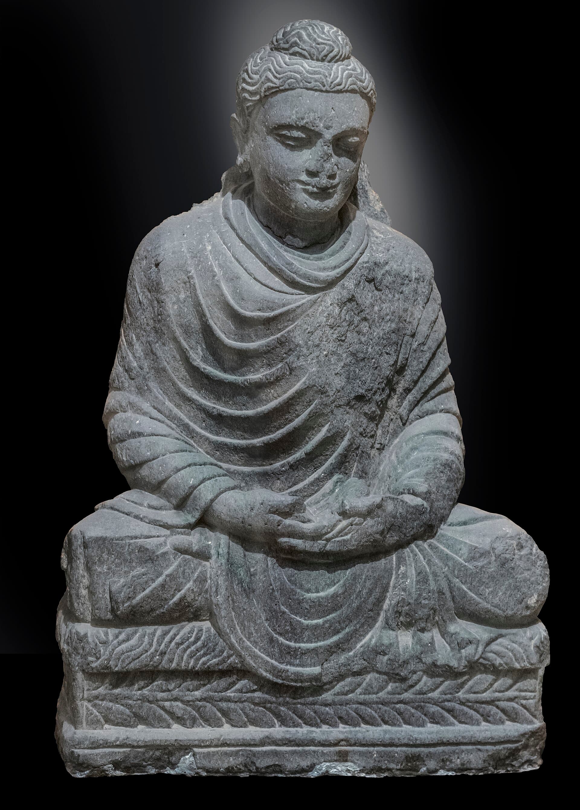 Ancient Gandharan schist statue of the seated, meditating Buddha from the Swat Valley, Pakistan