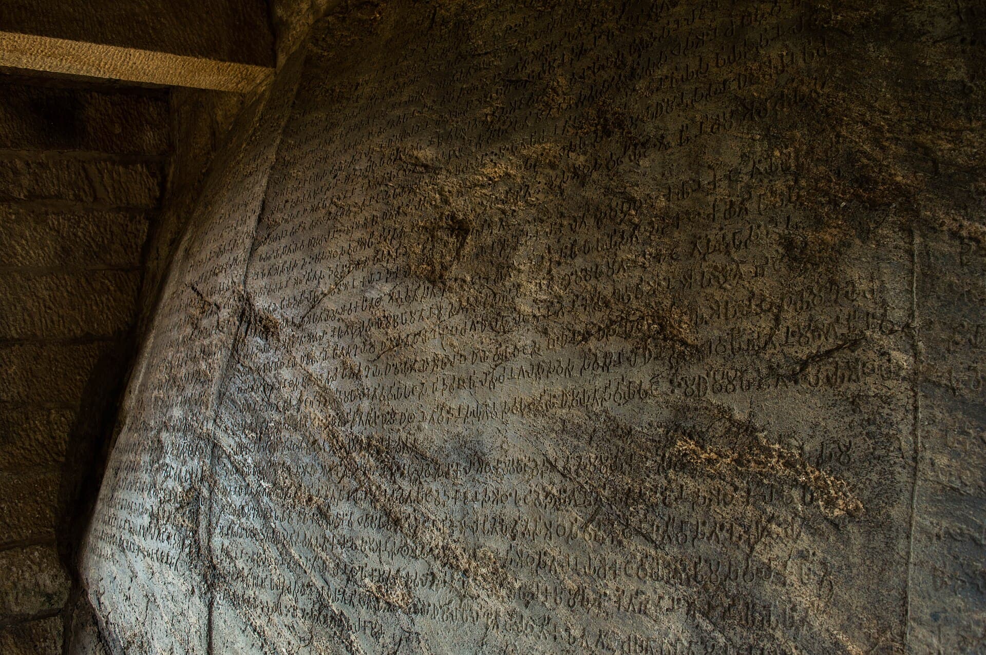 Close-up of the inscribed rock face of Ashoka's edicts at Dhauli — an immense, unmoving stone, echoing the essay's simile of the mind unshaken by praise or blame