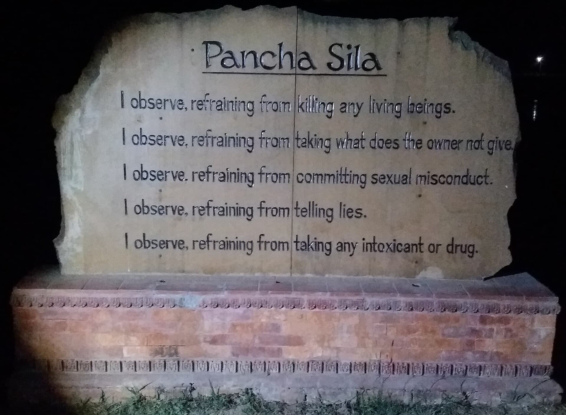 A stone marker inscribed with the Pancha Sila — the five precepts — at Lumbini Park, Nepal