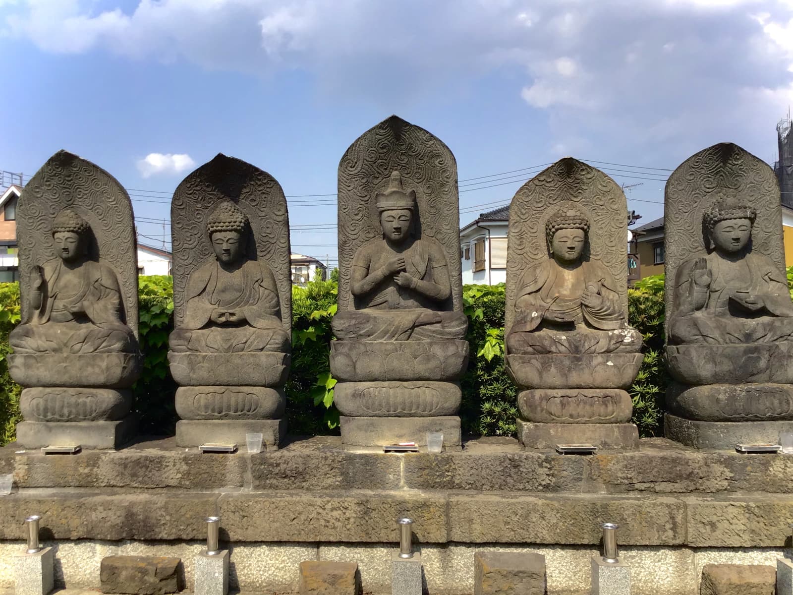 A row of stone Buddha statues at a Japanese Mahayana temple