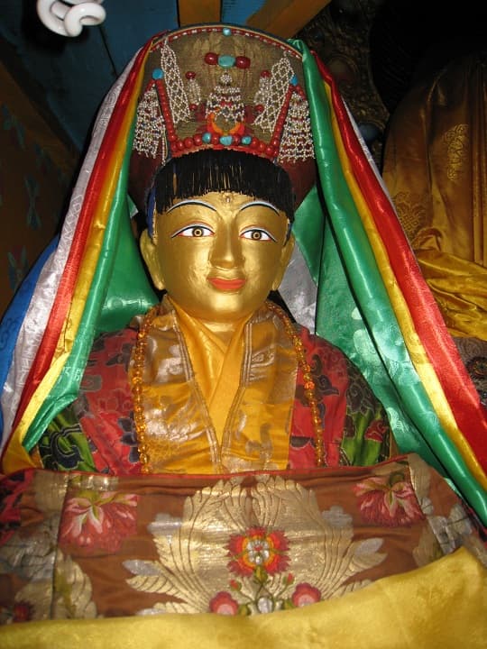 Gilded devotional statue of the yogi-poet Milarepa, dressed in ceremonial brocade and a jeweled crown, made by his root student Rechungpa
