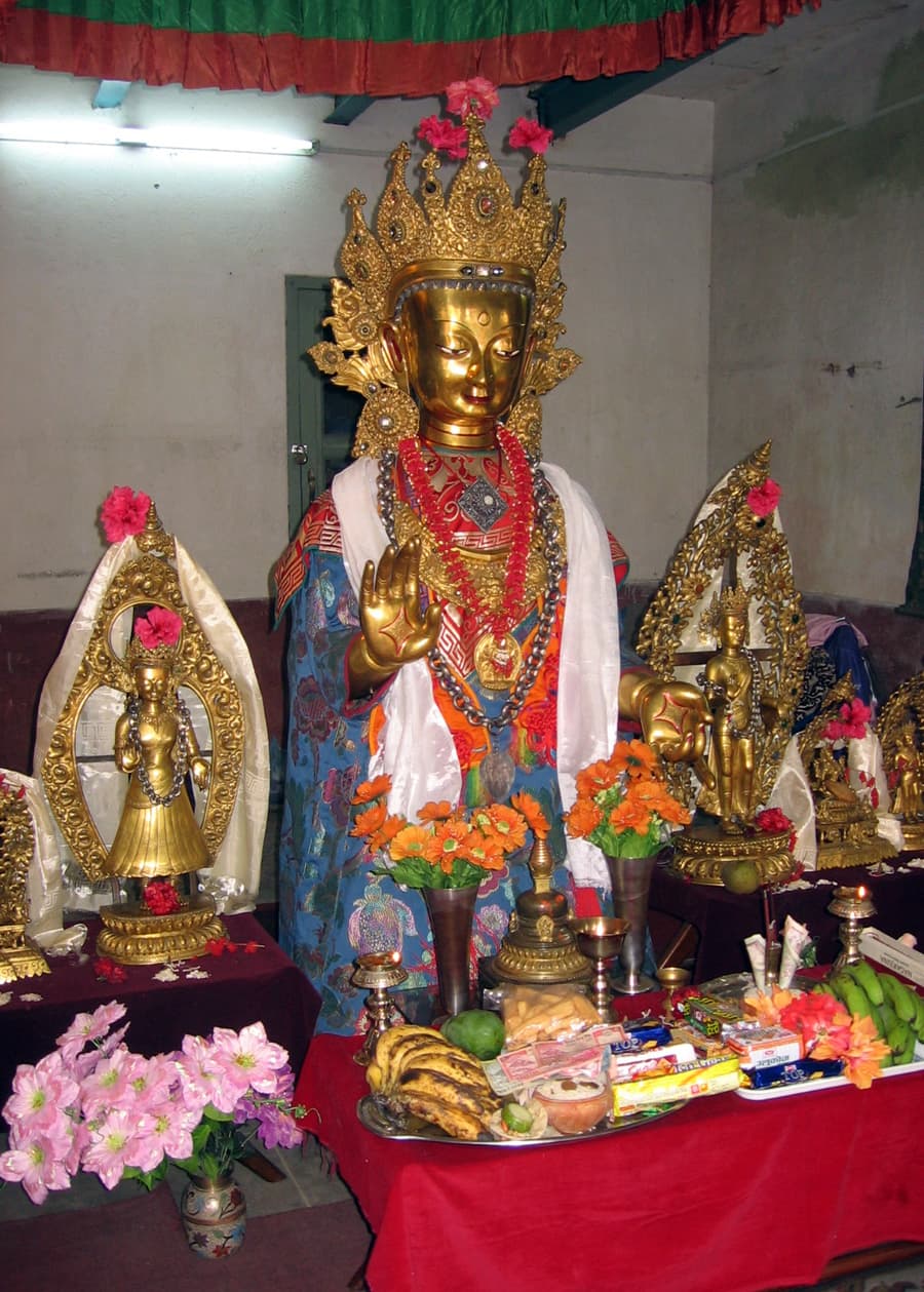 A gilded Newar Buddhist deity shrine with offerings in the Kathmandu Valley