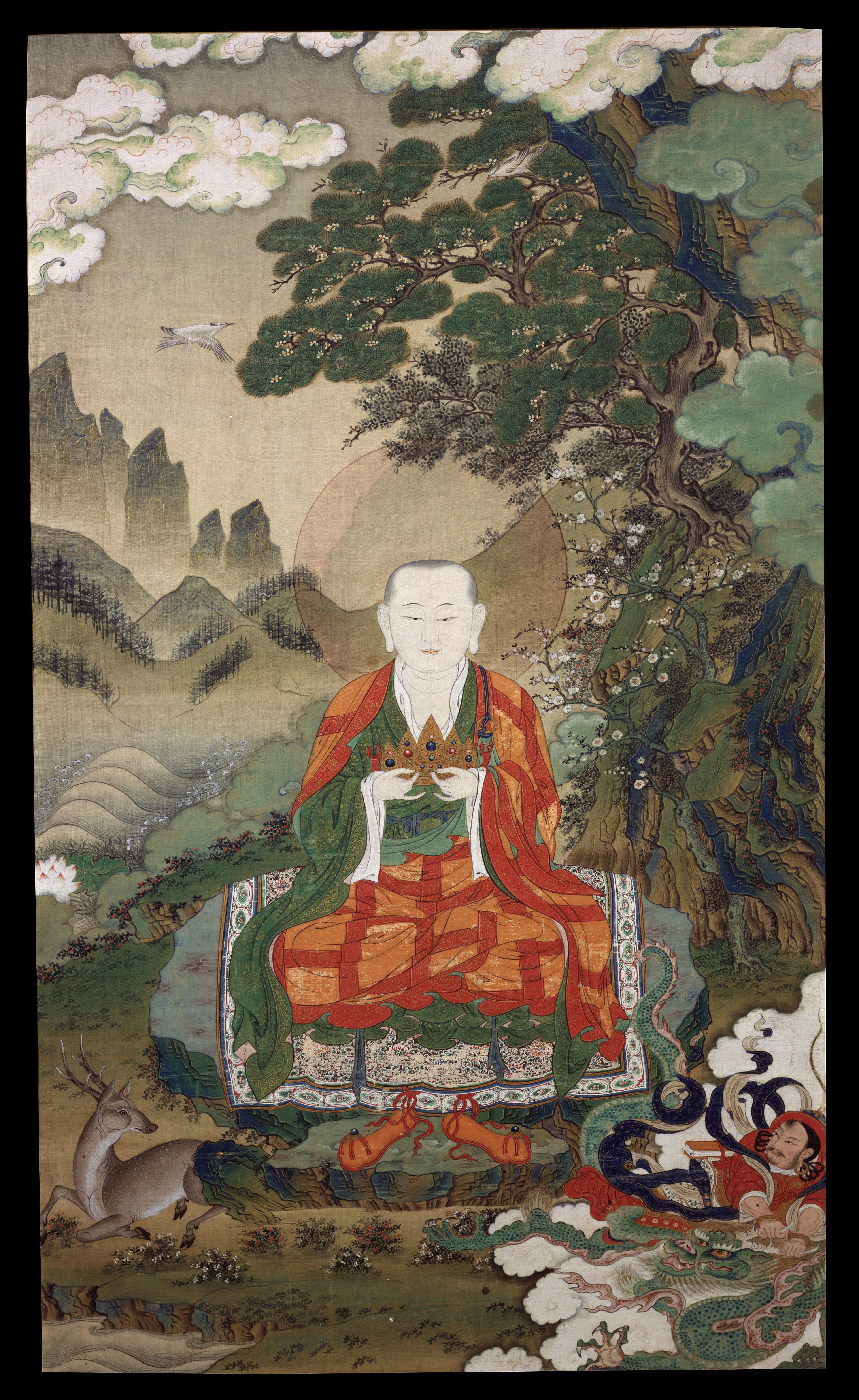East Asian thangka-style painting of the arhat Rahula seated beneath a pine tree in a mountain landscape, holding a jeweled crown, with a deer and dragon at his feet