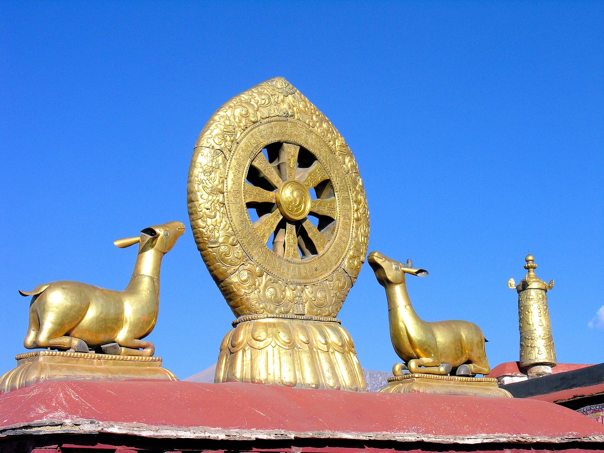 Golden Dharma Wheel flanked by two deer atop the roof of the Jokhang Temple, Lhasa