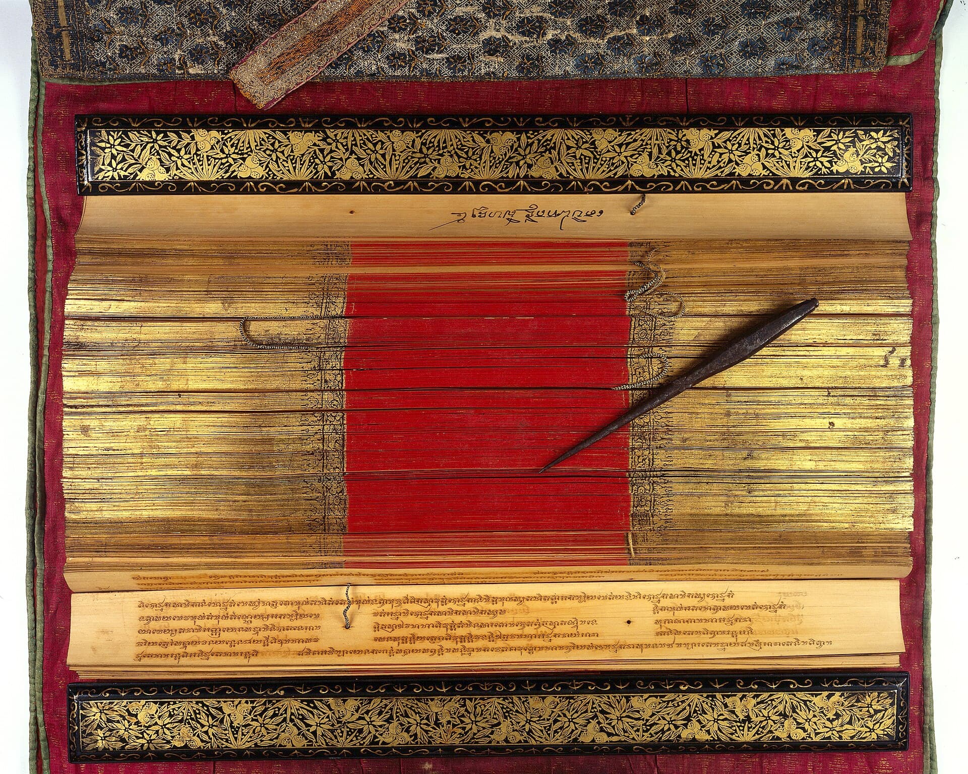 Thai palm-leaf manuscript with gilded covers and an iron incising stylus
