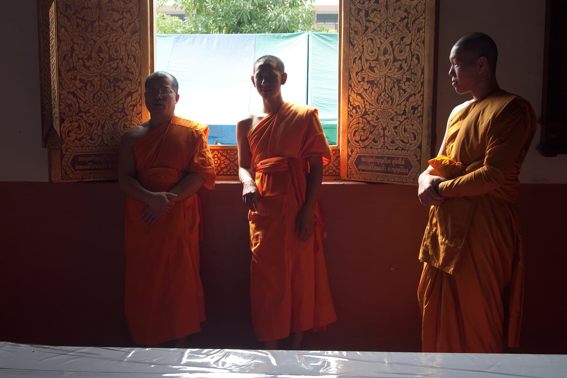 Theravada Buddhist monks in saffron robes at Wat Chedi Luang, Chiang Mai, Thailand