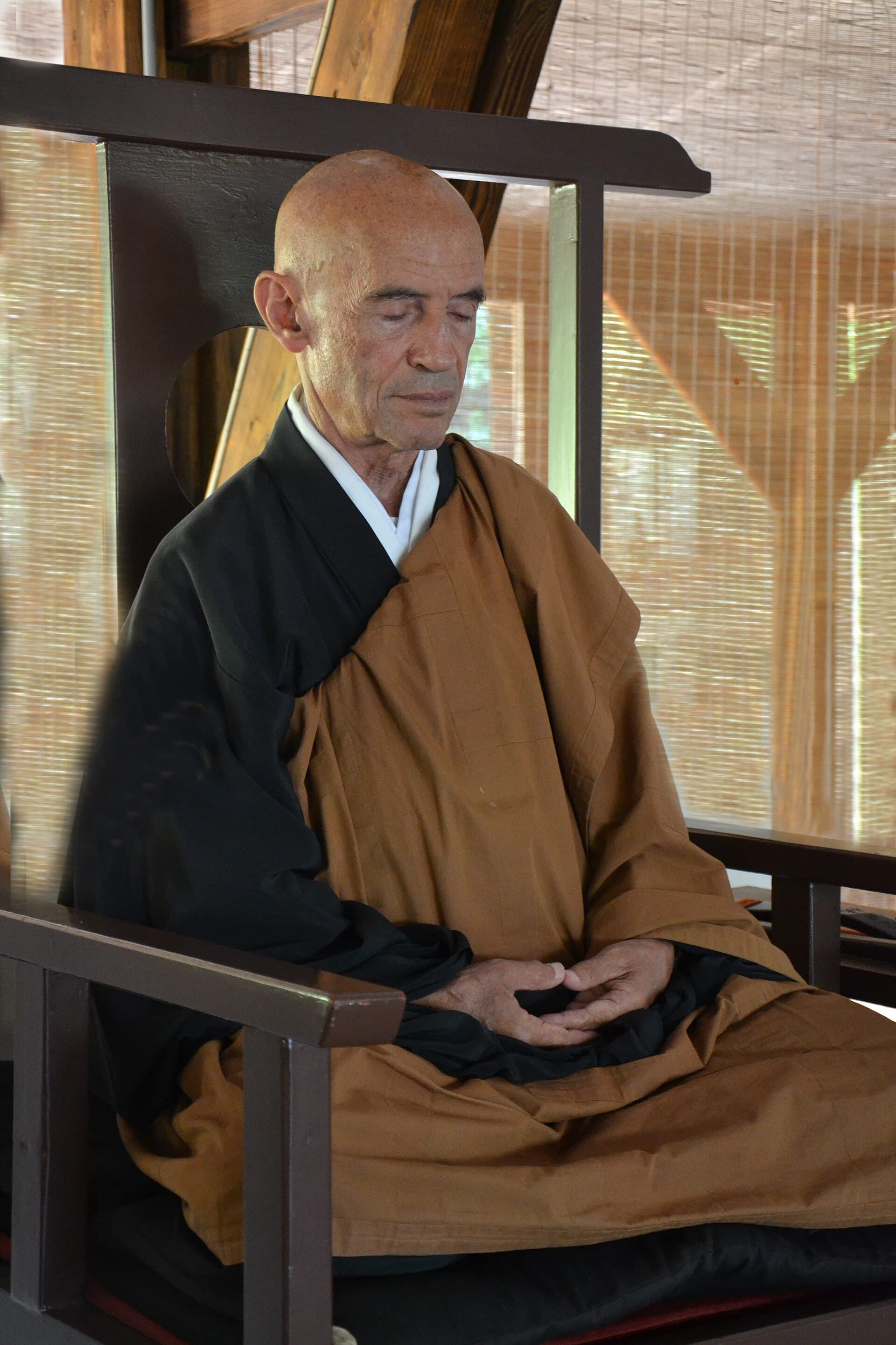 A Zen teacher seated in zazen meditation posture