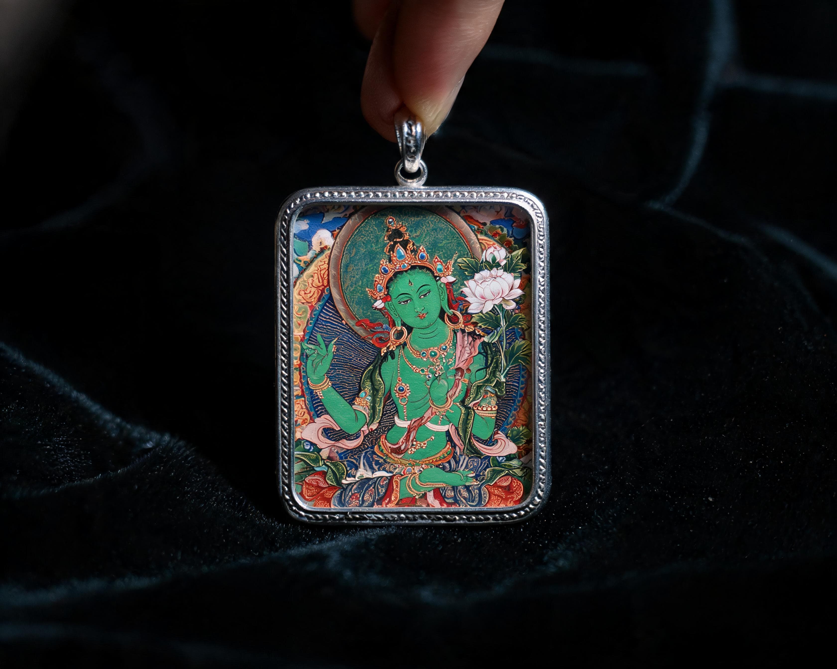 Hand-painted deity pendant in a silver frame