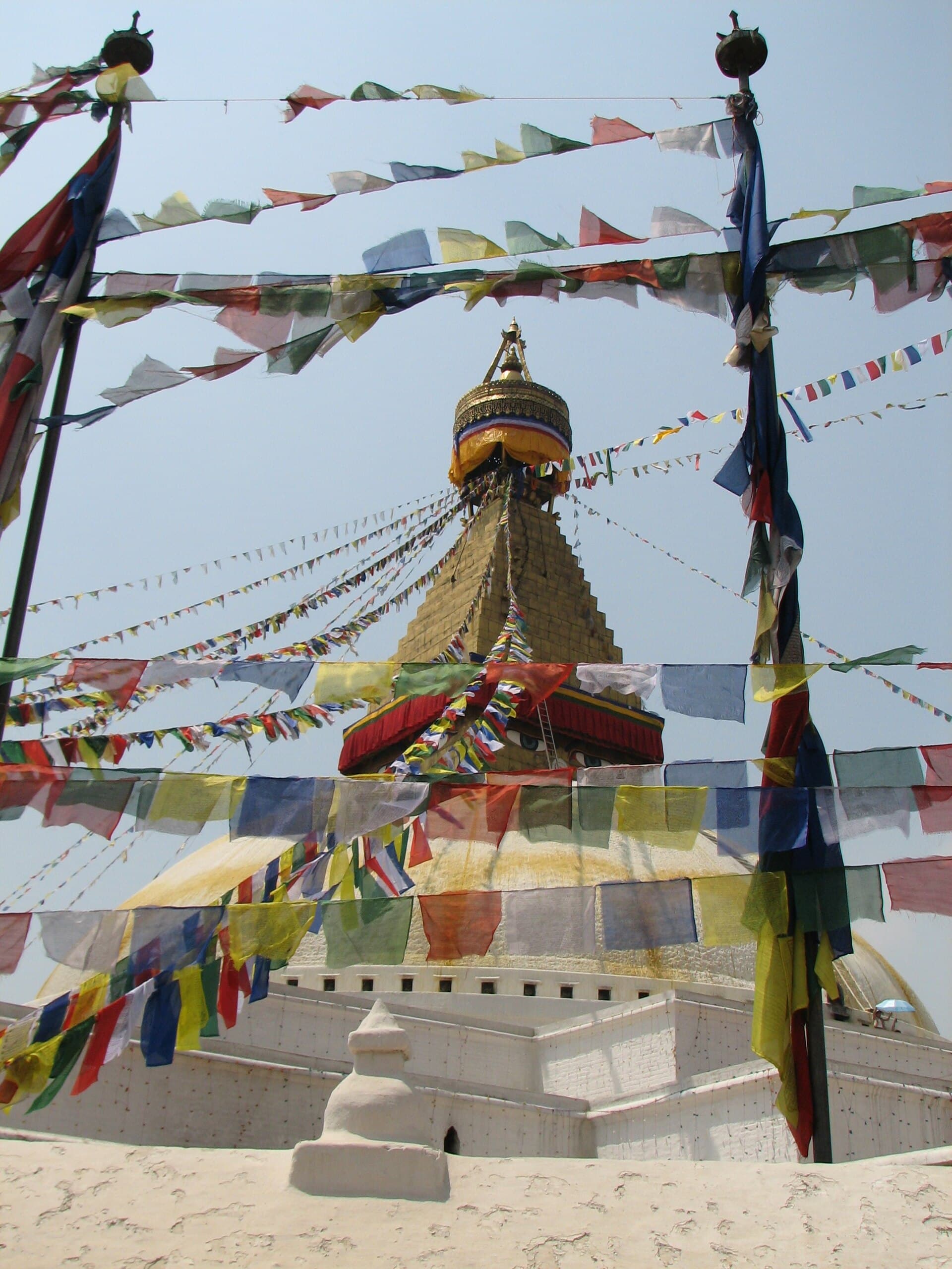 A whitewashed stupa with prayer flags