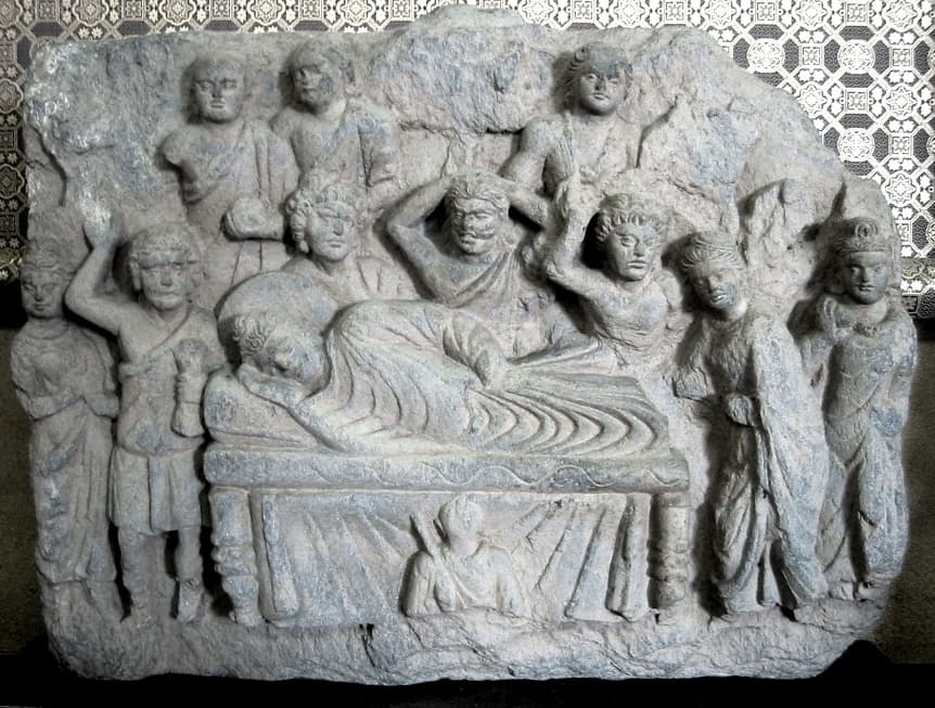 Gandharan stone relief of the Parinirvana of the Buddha, surrounded by grieving disciples