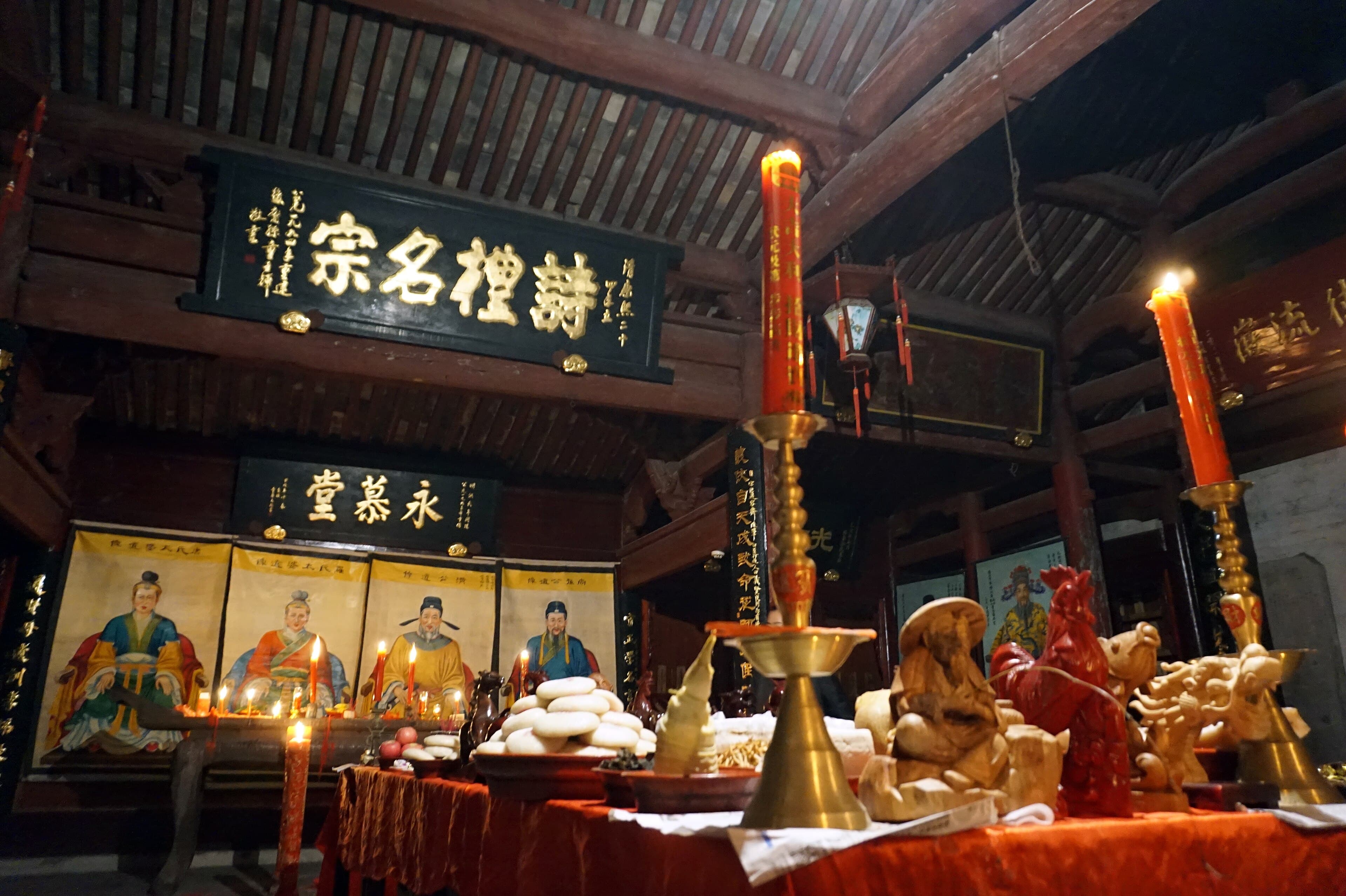 Ancestral portraits and offerings inside a Chinese clan ancestral hall