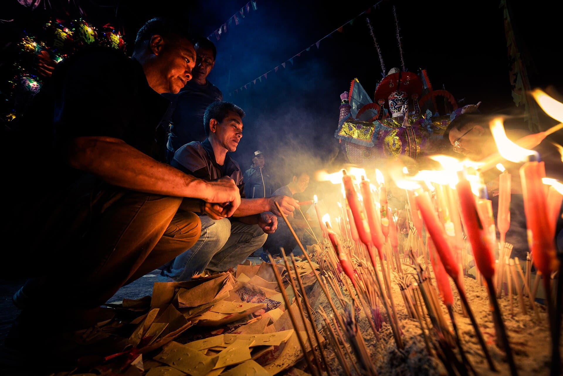 Worshippers lighting candles and incense during a Taoist jiao offering ritual